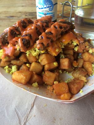 Breakfast Poutine cross section so you can see the intense potato excavation process. You can order this with bacon or sausage. The breakfast sausage was fantastic. at Munchies Vegan Diner in Santa Ana