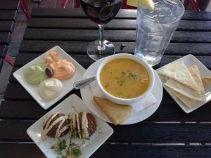 Curried coconut soup, hummus sampler, and falafel. Oh yeah! And a glass of Cabernet Sauvignon! I'm sitting outside and rock and roll playing and there's a water fountain too at Pita Jungle in Tempe