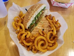 Vegan "chicken" panini and curly fries at Hot Krust in Orlando
