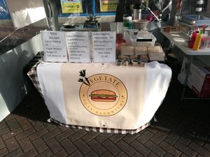Vegan market stall selling hot sandwiches, cold sandwiches, kale chips and cakes. at Vegetate in Aylesbury