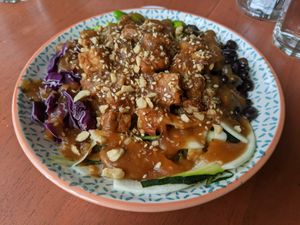 Bowl with tempeh and a sweet sauce at One Happy Bowl in Noord