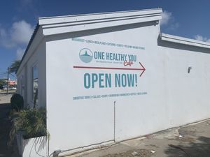 The sign on the side of the buildingg  at One Happy Bowl in Noord