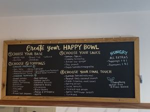 Menu on the wall  at One Happy Bowl in Noord