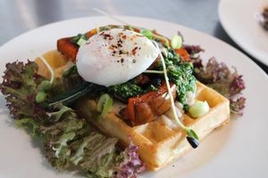 Brunch waffle with roasted pumpkin, kale pesto & poached egg at Jord & Bord Örnahusen in Borrby