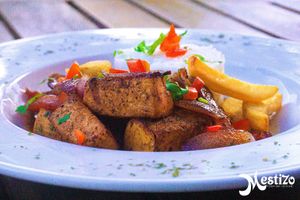 TOFU SALTADO
Extra firm Chunks of Tofu marinated in our home made soy sauce tomatoes onions yellow pepper and fries.  at Mestizo Fusion Cuisine in West Palm Beach