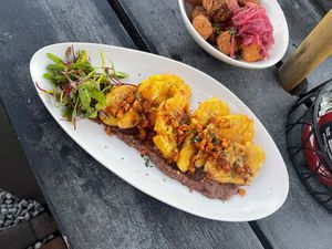 Tequila Lime Tostones- black bean puree, double fired plantains, picante hazelnuts, sweet tequila lime glaze.
(Vegan) at Newcastle Publick House in Newcastle