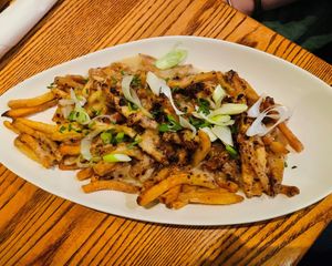 Vegan Cheesy Fries- hand-cut fries smothered in a homemade vegan cheese sauce, topped with toasted picante hazelnuts. at Newcastle Publick House in Newcastle