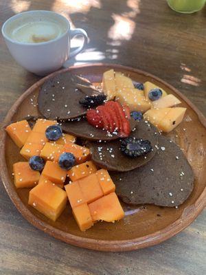 Vegan pancakes with fruit and cappuccino with coconut milk at Piyoli in Puerto Escondido