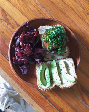 The vegan burger choice on grain bread with sweet potato chips 💕 at Piyoli in Puerto Escondido