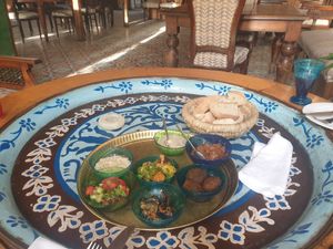 Selection of vegan mezzes with bread on our beautiful table. at Sofra in Luxor