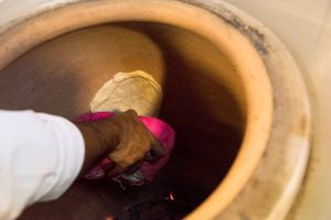 Making authentic flatbread in the tandoor (clay) oven at Uit India in Alkmaar