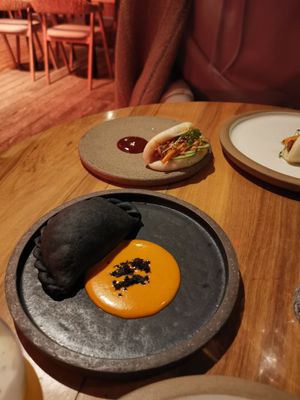 Bao bun. Black empanada. at SACRO in Buenos Aires