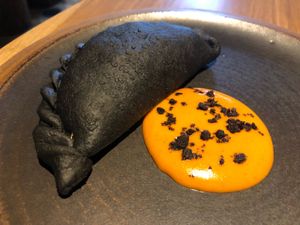 Activated charcoal empanada at SACRO in Buenos Aires