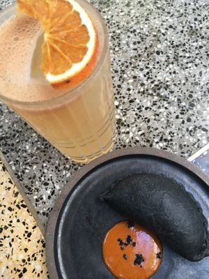 Black empanada and citric kombucha in Sacro. at SACRO in Buenos Aires