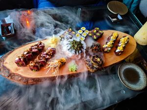 Platter full of vegan sushi, with dry ice fog at Secret Garden at Secret Garden in Berlin