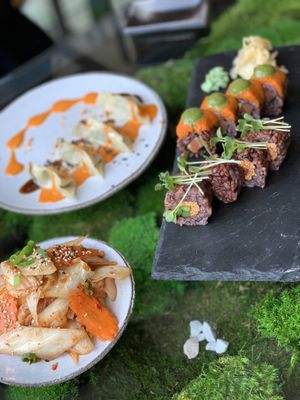 Kimchi, dumplings and sushi. Note the v salmon at Secret Garden in Berlin