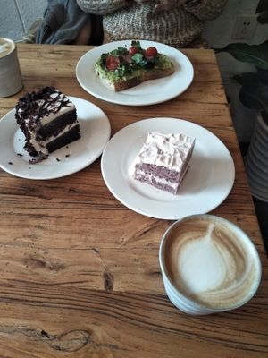 Avocado on toast (without feta), coffee with cashew milk, two cakes. at Egg in Shanghai