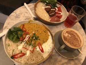 Peanut butter and sweet potato Dhall, hot chocolate with oat milk, charitea and falafel bowl.  at Vertigo - Cross St in Manchester