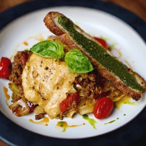 Pappardelle Bolognese, pasta in our signature tomato sauce with minced vegan meat, sautéed onions, red bell pepper, roasted cherry tomatoes and fresh basil. at Manggis in Canggu in Canggu