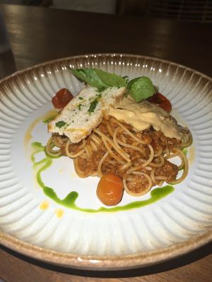 Spaghetti bolognese and bread with pesto (The sauce on top gave me béchamel vibes)   at Manggis in Canggu in Canggu