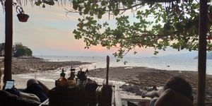 Sunset at low tide from lying down area at Benny's On The Beach in Koh Lipe