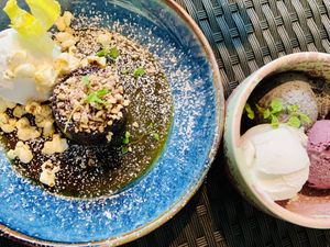 Sticky toffee pudding next to a trio of ice creams  at Redemption - Seven Dials in London