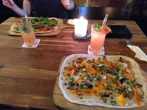 From top left: flammkuchen with pumpkin, blood orange lemonade, and with mushrooms at Mokel Bar in Muenster