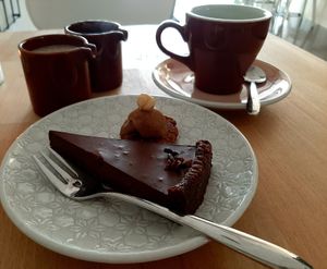 Chocolate cake and coffee with homemade almond milk at Mandlove Srdco in Bratislava