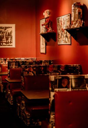 Booths covered in film shots. at Queen City Cinema Club in Bangor