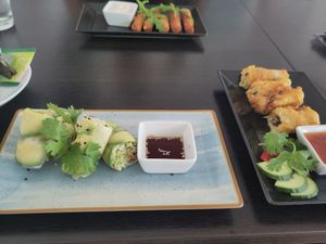 The avocado rolls and spring rolls, on the other side of the table are the cheese sticks. at Loving Hut - Maria Kuhn Gasse in Vienna