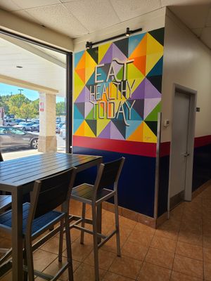 Seating and wall art at Wrapway in Charlotte