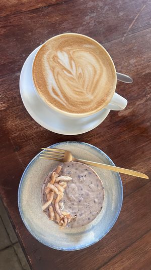 Vegan cheesecake and latte.  at The Garden Café in Granada