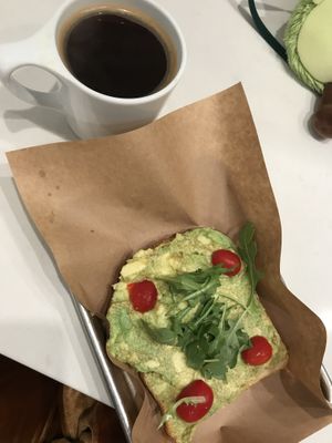 Long black and half order of avocado toast on sourdough sin feta (honestly, the seasoning was FIRE) at Blue Door Coffee in The Woodlands