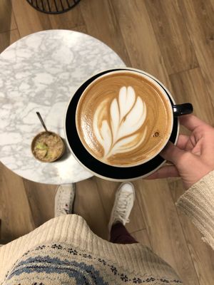 A perfect almond milk latte and a delicious cup of oatmeal with apples!  at Blue Door Coffee in The Woodlands
