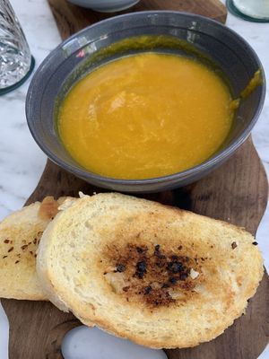 Green curry pumpkin soup garlic bread at Gourmet Cafe - Petitenget in Seminyak
