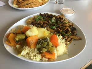 Shawarma on a plate with hot couscous  at Hummus Bar in Haifa