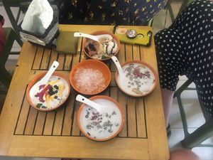 Yogurt with jackfruit, red beans, caramel mixed bowl with ice cream, sweet banana at Little Bowl in Hanoi