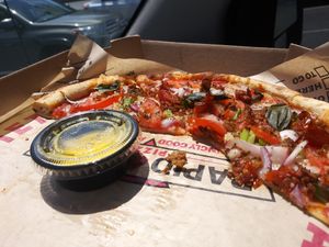 Vegan cheese pizza with meatless sausage , onions, garlic and spicy marinara sauce with a side of garlic sauce at Rapid Fired Pizza in Spartanburg