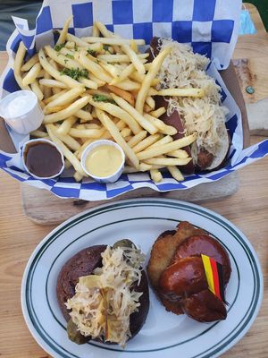 Srirach bratwurst with fries, mayo, german mustard and curry ketchup and schnitzel and brat sliders 😍 at Hinterhof in Los Angeles