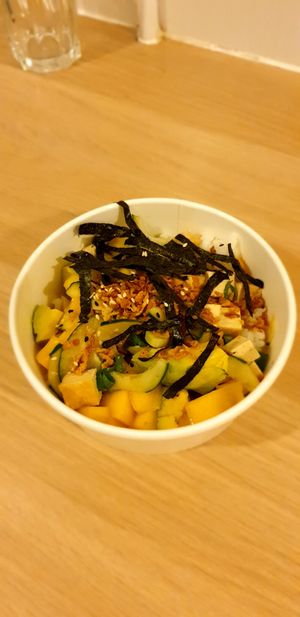 Tofu poke bowl with organic tofu, sushi rice, avocado, mango, cucumber, fried onion, nori strips and ponzu sauce at Local in Lisbon