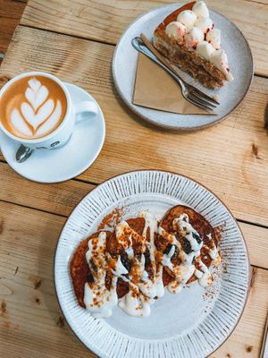 Oat milk cappuccino, raspberry & lemon cake, oat & banana pancakes  at Jaunty Goat Coffee - Northgate St in Chester