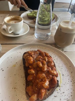 Boston beans, avo toast, iced coconut latte and oat flat white  at Jaunty Goat Coffee - Northgate St in Chester