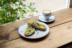 Avocado on toast and oat milk flat white at Northgate Street at Jaunty Goat Coffee - Northgate St in Chester
