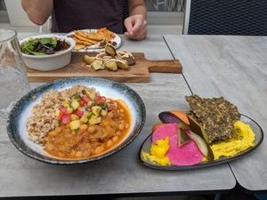 The hummus with seed bread and the potatoes are so good! at Stem & Glory in London