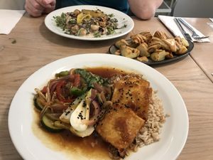 Gnocchi in the background, potatoes in the centre, baked tofu yakitori in front  at Stem & Glory in London
