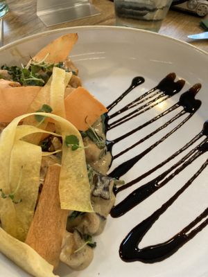 Swede gnocchi with roasted chestnut mushroom & spinach in ‘gorgonzola’ cream with spiced walnuts, aged balsamic, yellow carrot curls & micro sage.  at Stem & Glory in London