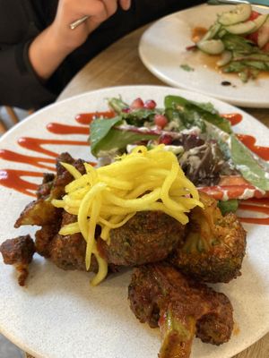 Bang Bang broccoli toasted in sweet & spicy sauce served with on sunshine salad & topped with spring onion   at Stem & Glory in London