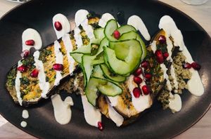 
Aubergine Chermoula
Slow roasted eggplant on quinoa with chermoula sauce, pomegranate, cucumber salad and lime dressing at Stem & Glory in London