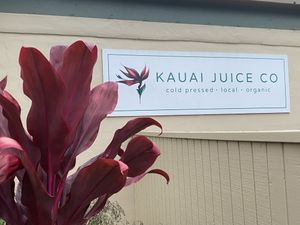 Signage visible from the road  at Kauai Juice Co. in Koloa