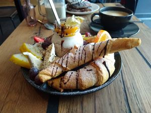 Sweet breakfast with croissants, fruits, margarine, nuts, various spreads and soy yoghurt. at Veg room in Berlin